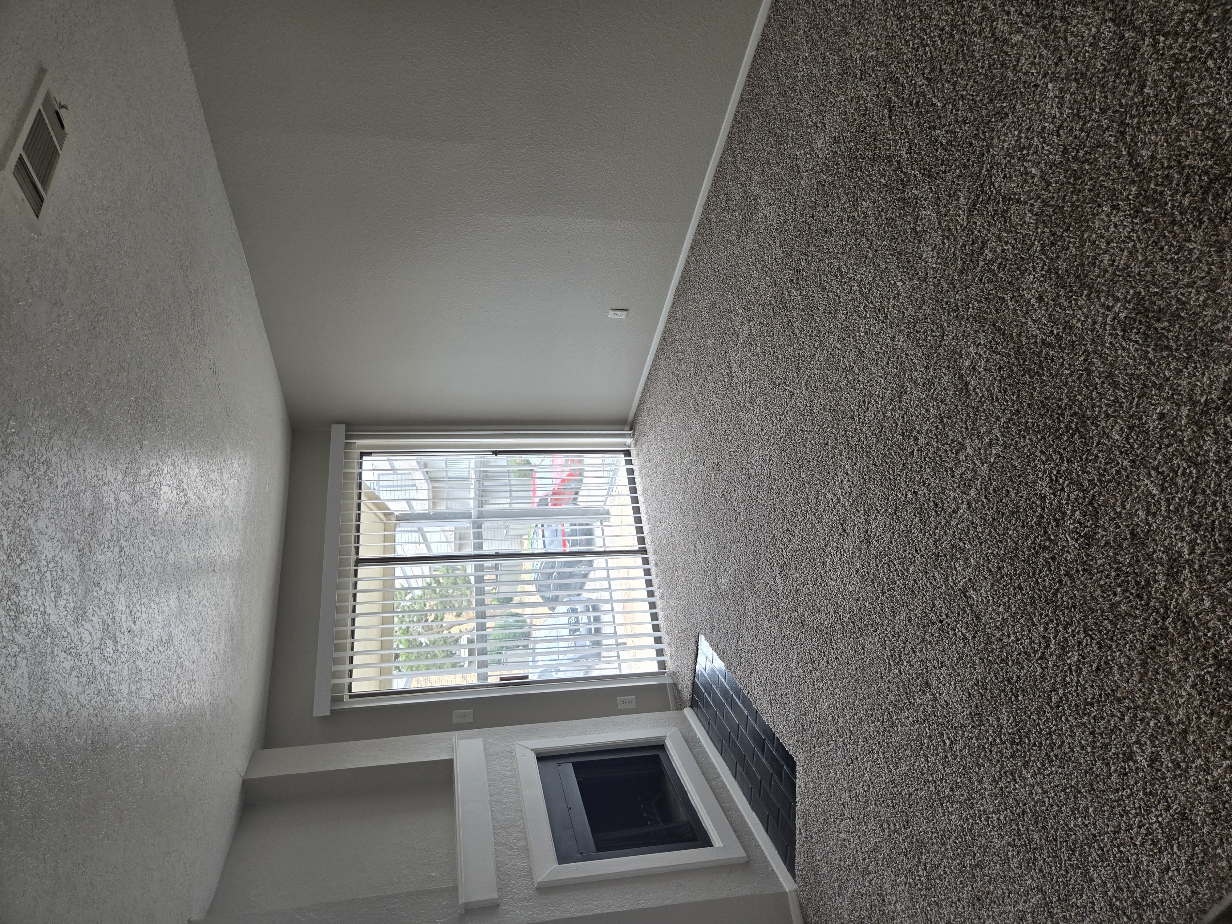 A window with blinds is open and lets in light.